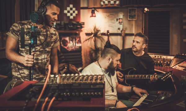 Professional music band recording song in boutique recording stu Professional music band recording song in boutique recording studio.