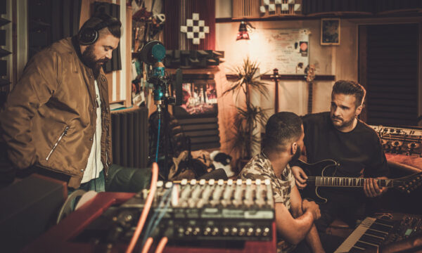 Professional music band recording song in boutique recording stu Professional music band recording song in boutique recording studio.